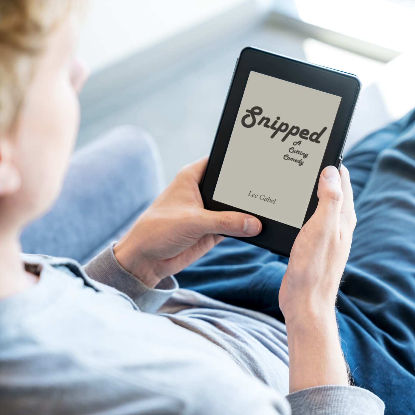 Person relaxing and reading Snipped on an e-reader.