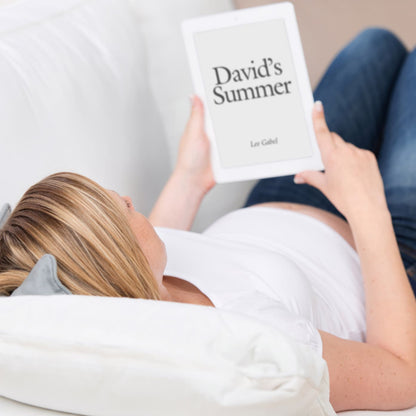 Pregnant woman reclining and reading David's Summer on an e-reader.