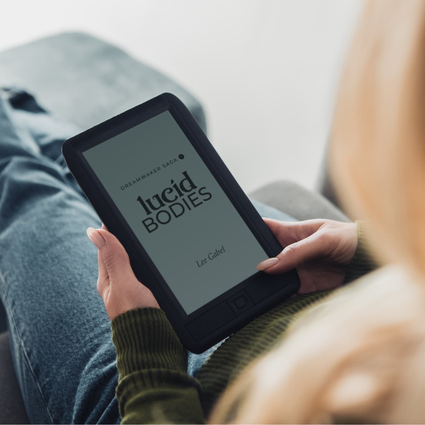 Person relaxing and reading Lucid Bodies on an e-reader.